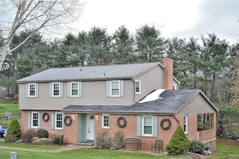 FRONT EXTERIOR WITH PORCH.  Stop by for a visit.  Why not come back to live?