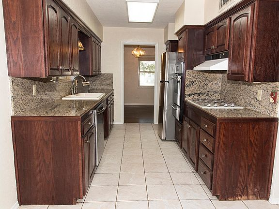 All stainless, eat-in galley kitchen with broiler, gas cook top, solid wood cabs, and granite tile.