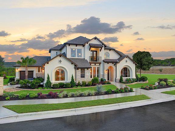 A stately two-story home featuring stone accents