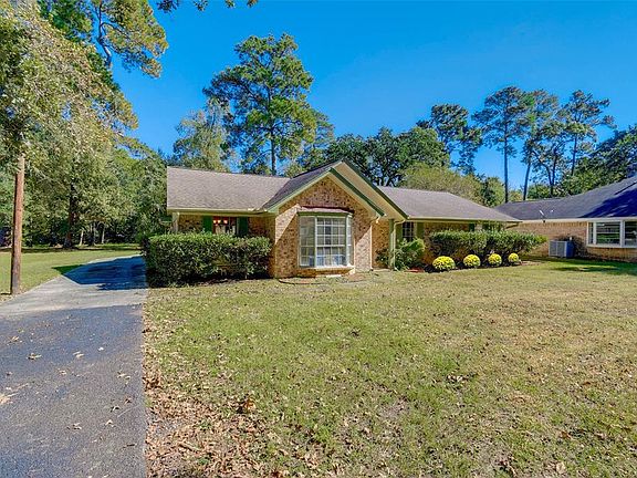Your own acre nestled among mature trees provide for a quiet country living, but with easy access to highways, as you're only minutes from I-45.