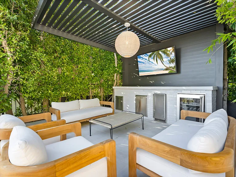 Kick back in a shaded lounge with a Smart TV and built-in bar.