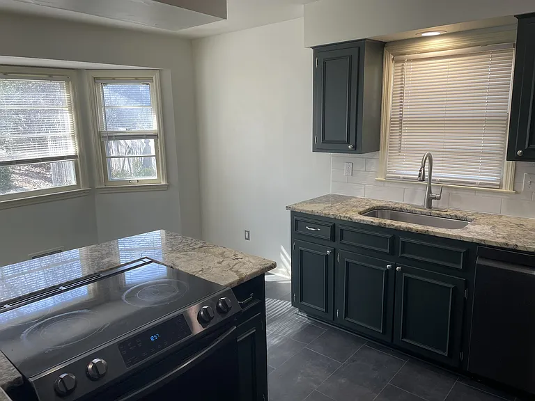 New luxury vinyl flooring seamless flowing to eat-in kitchen area.