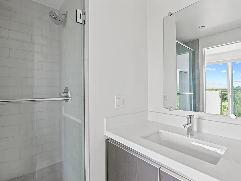 Bathroom with Stand-Up Shower with Glass Door and Vanity Cabinet Storage