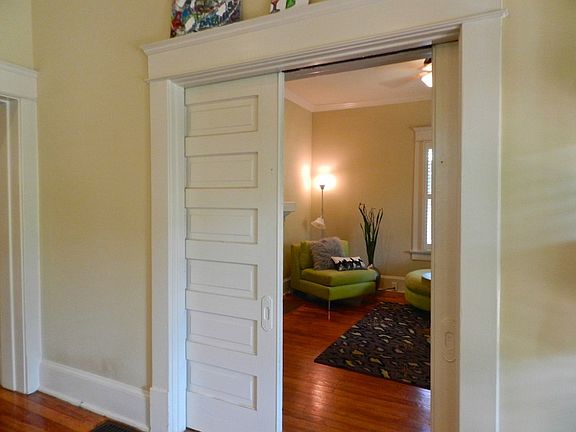 Parlor pocket doors can be closed to create a sitting room for master bedroom... parlor also features a working fireplace with coal basket installed... how romantic!