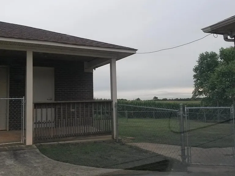 fenced in back yard from driveway