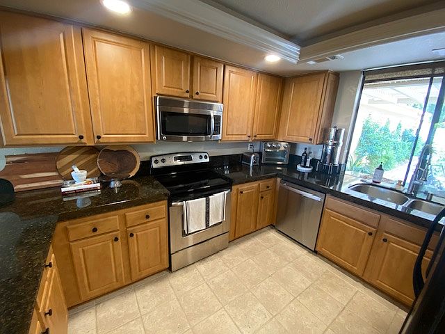 Fully equipped kitchen with view to front courtyard.