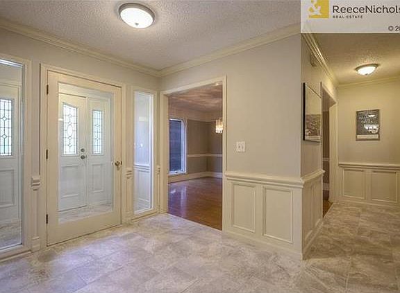 Unique vestibule, also conserves energy. Gorgeous tile floors.