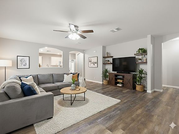 Large living room with beautiful wood-like luxury vinyl plank flooring. Virtually staged