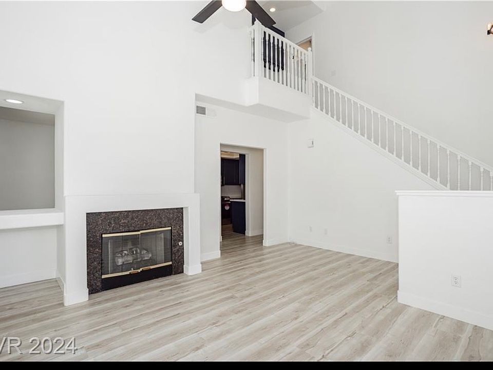 entryway, living room with fireplace and backyard access