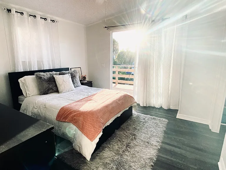 Master bedroom sliding glass doors to balcony