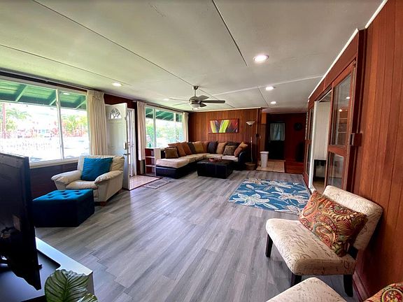 Living room opens to the front yard. Large windows let in lots of light and breeze.