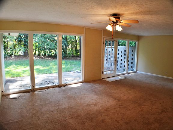 Living room with beautiful natural light from large windows and view of the backyard.