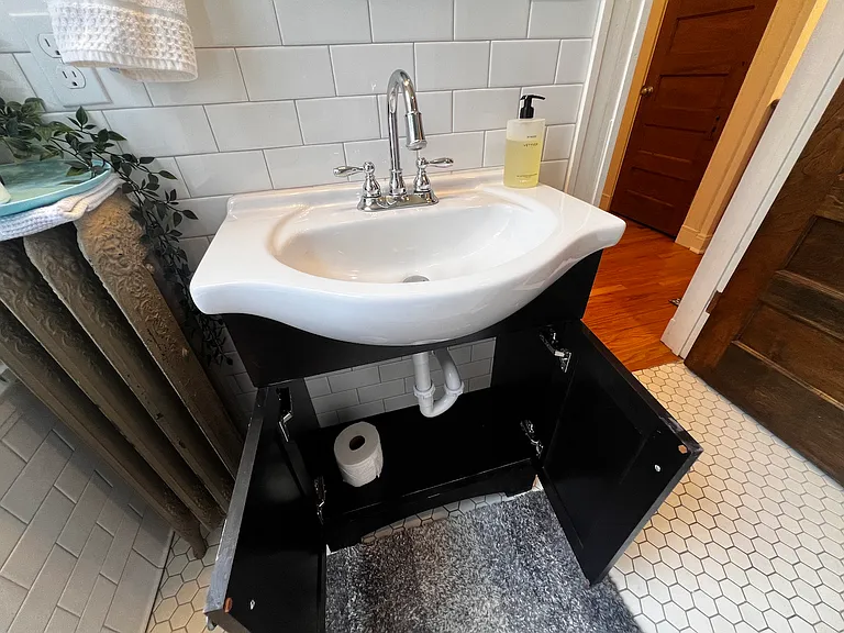 Room for supplies under bathroom sink.