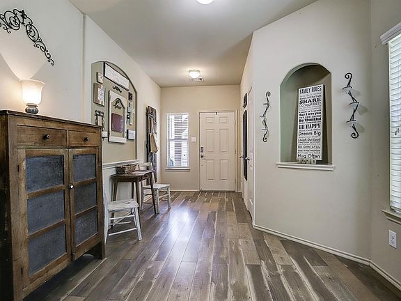 You will enter the home in this long hallway with art niche, window to let the light in and the recent updated floors.