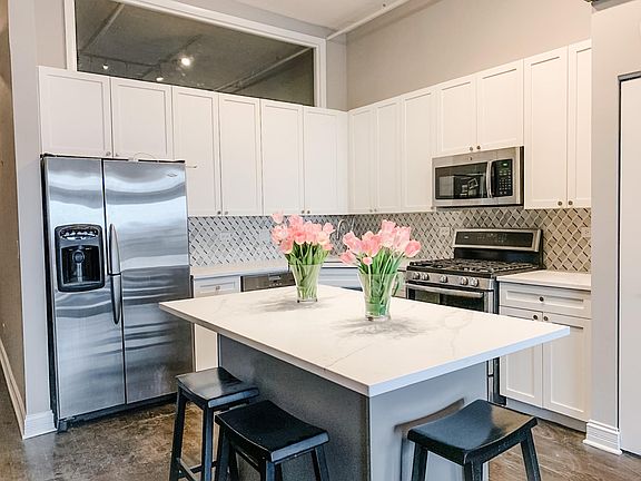 Kitchen renovated last year - new quartz countertops, expanded island, new marble backsplash, new 10" deep sink, newer gas oven/range, microwave and dishwasher.