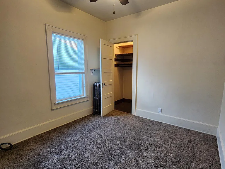 Bedroom #3, smaller bedroom. Fits a queen bed easily in two different layouts. Right corner in photo, or left corner (cut out of photo)