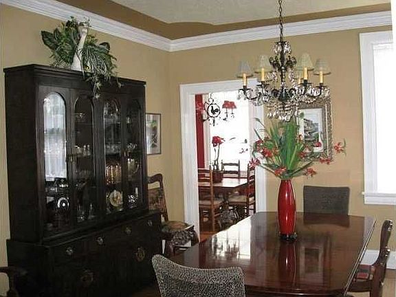 Formal dining room features deep plaster molding and hardwood floors