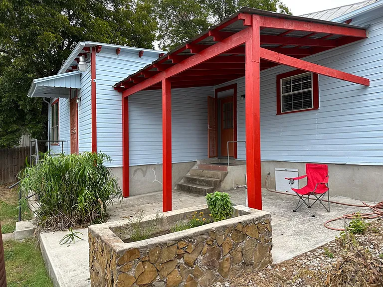 Covered back porch. Two back doors, one into the kitchen and one into the laundry room.