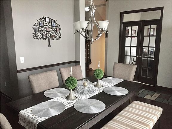 Dining room and office located off the entry. Private office with glass French door and window transom.