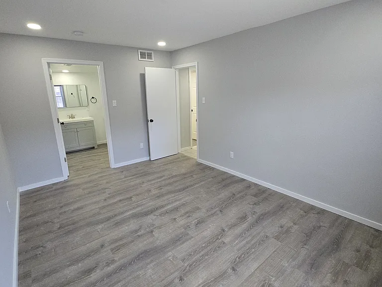 Master suite looking into room at the bathroom from exterior wall