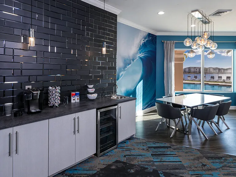 Enjoy complimentary coffee in the stylish clubhouse, complete with modern seating and a scenic lake view.