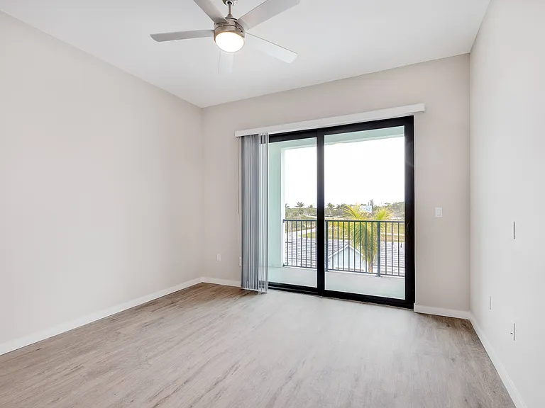 Imperial Crossing Luxury Apartment Homes unit showing a bedroom with patio/balcony.