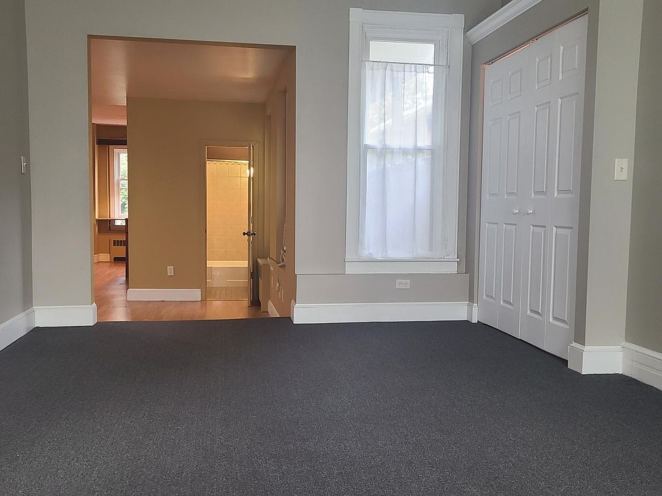 Living room with extra closet or desk area to the right with bifold doors