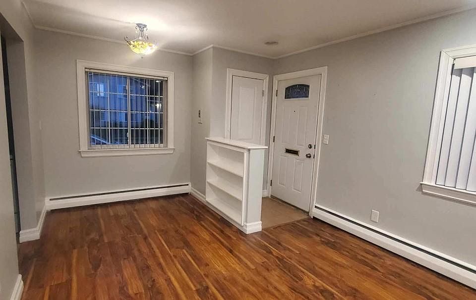 Living room looking into dining nook and front door