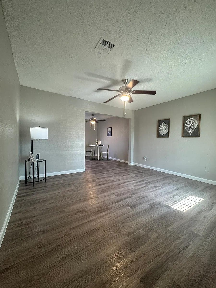 Our newly renovated townhomes feature an open, bright layout with modern wood_style flooring, neutral walls and plenty of natural light. The seamless flow into the dining area and updated fixtures create a comfortable, versatile space for everyday living. - Garner Park Apartments