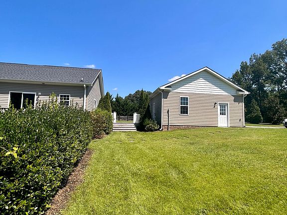 Backyard behind garage and house