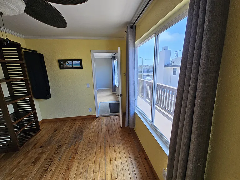 The front bedroom radiates with sunshine and ocean breeze.