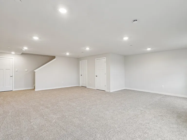 Extra large Recreation Room in Basement with natural lighting, walk out, LED lighting and storage - Ideal for entertaining and can serve multiple recreational purposes offering valuable added living space