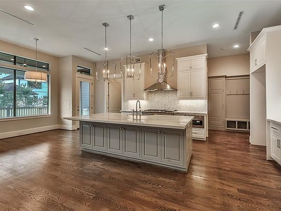 Island kitchen with tons of counter space. Kitchen and butler's pantry feature Cambria Quartz countertops. Large walk-in pantry sits just off the mud-room.