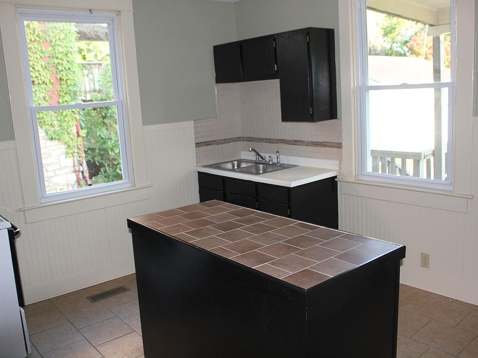 Kitchen with island and small deck behind.
