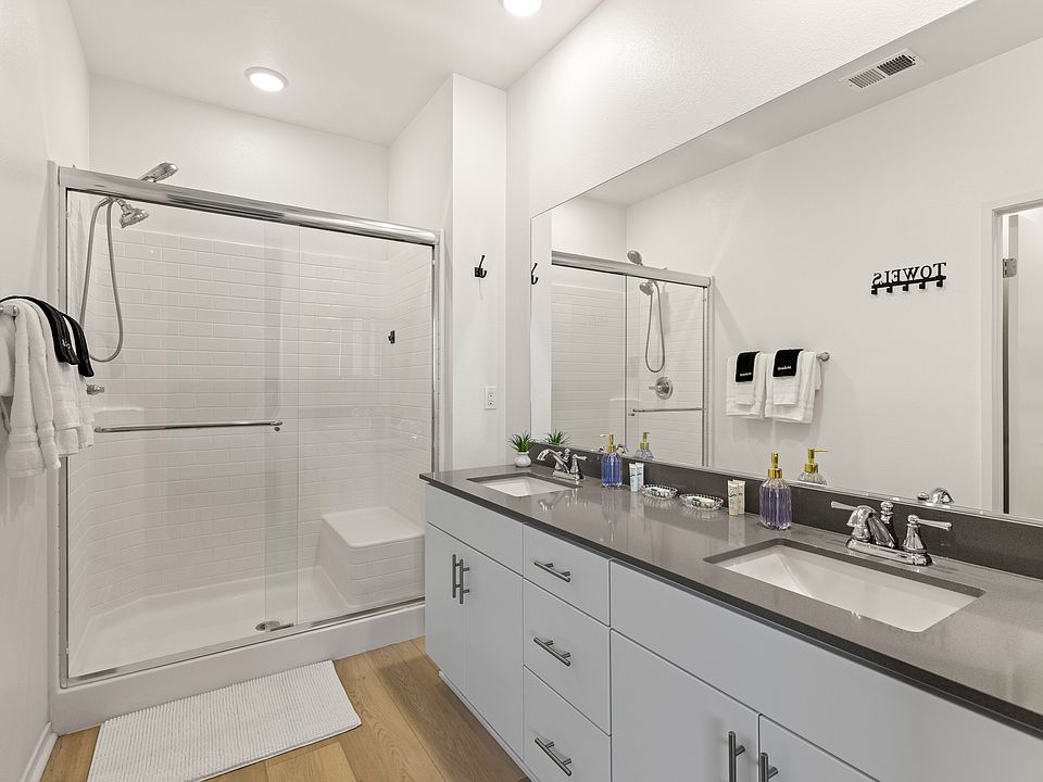 Stylish bathroom with a large mirror and all the amenities for a luxurious experience.