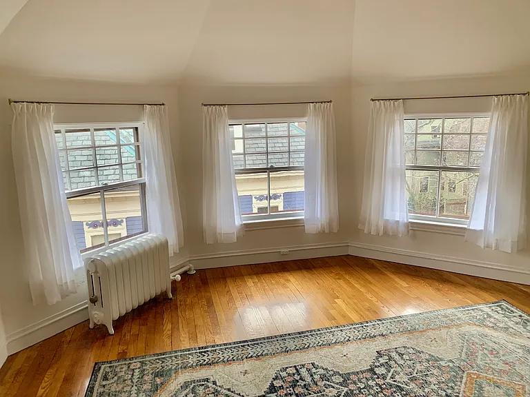 bedroom with curtains and area carpet
