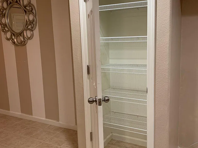 Dedicated pantry that is easily accessible in the kitchen.