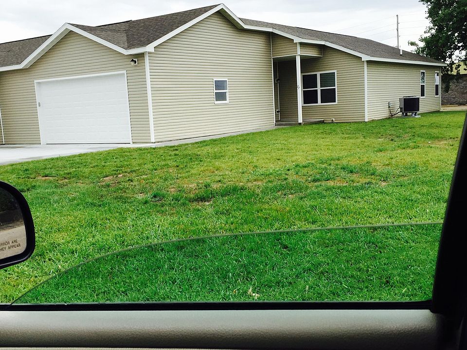 outside showing garage and front door