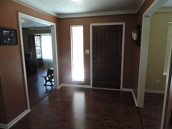 Impressive Entry with designer Paints & Rich Wood Laminate Floors!
