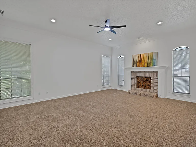 one of two large living rooms with a faux fireplace.
