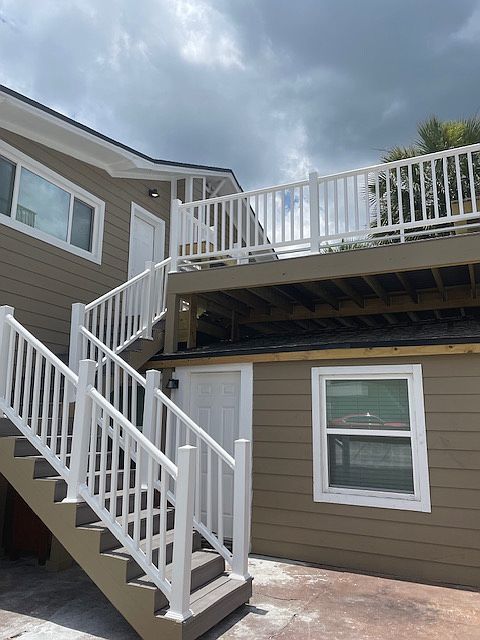 View of the stairs to the front door and spacious deck!