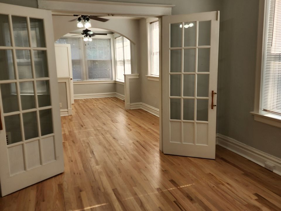 View from the middle room looking toward the front two rooms with new modern ceiling fans in each.