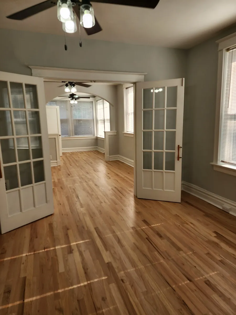 View from the middle room looking toward the front two rooms with new modern ceiling fans in each. - 4340-4342 De Tonty St #4340A