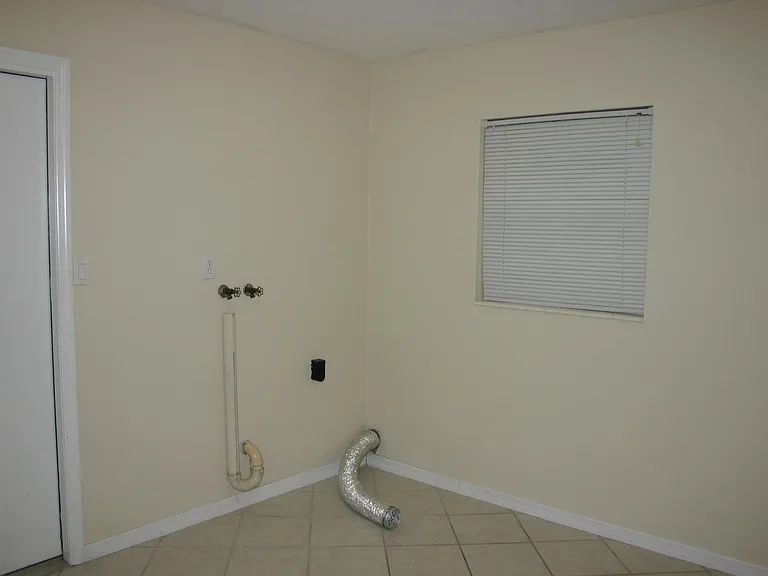 Large laundry room big enough for both washer/dryer and office