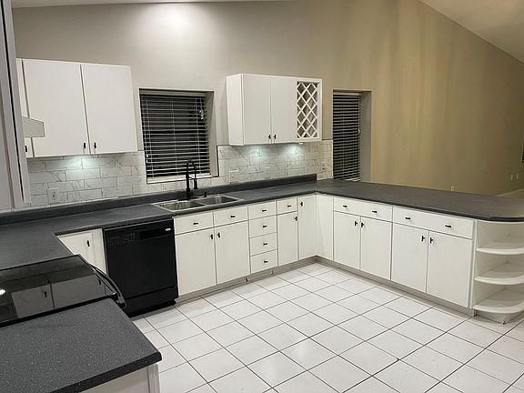 Upgraded appliances with new backsplash and new can lighting