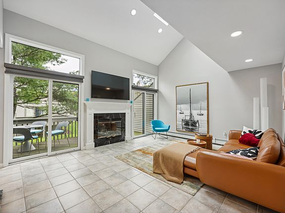 Living Room With Gas Fireplace & 2 Glass Sliding Doors To Deck.