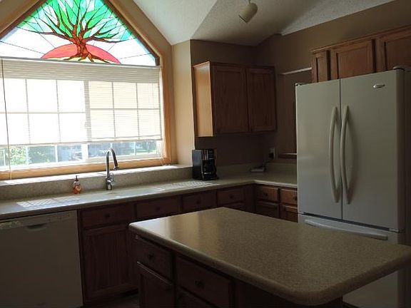 Kitchen features newer appliances, beautiful tile flooring, and extensive cabinetry