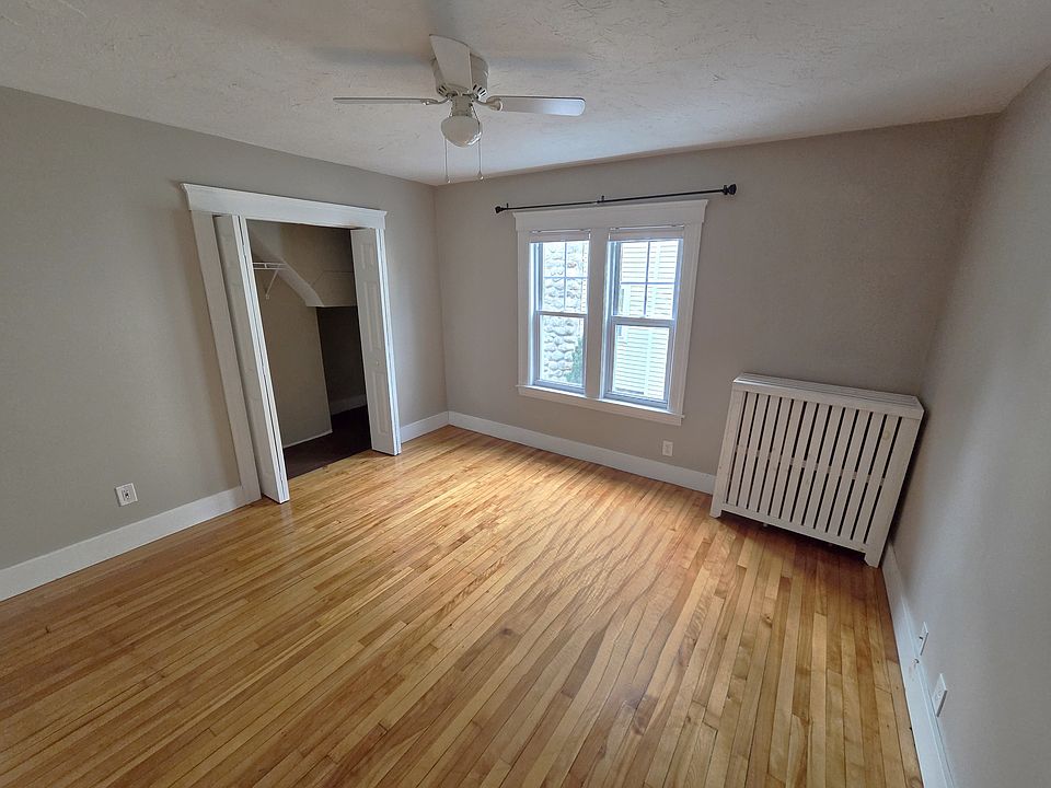Large bedroom with ceiling fan and closet.