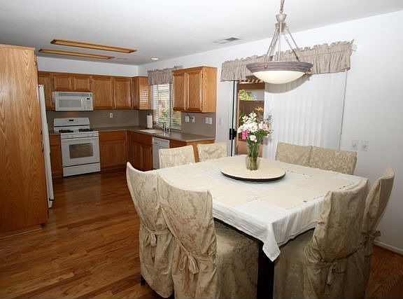 DINING ROOM AND KITCHEN WITH SUPREME OAK-FLOORS.