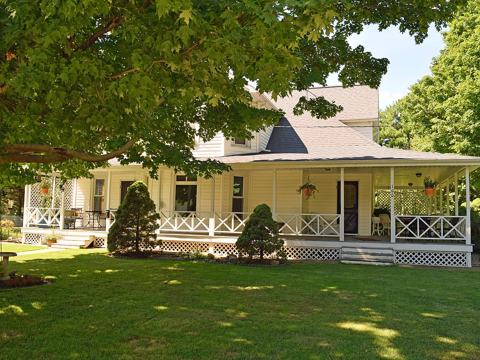 Wrap around porch and trees 